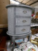 A silver coloured 3 drawer chest.