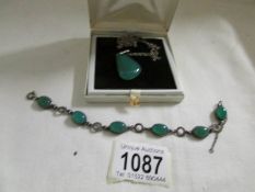 A jade pendant and bracelet.