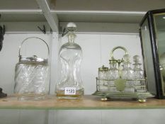 A 6 bottle Victorian cruet, a glass biscuit barrel with plated fittings and a glass decanter.