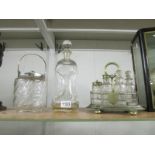 A 6 bottle Victorian cruet, a glass biscuit barrel with plated fittings and a glass decanter.
