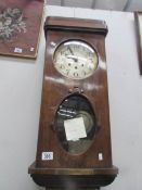 A wall clock with key and pendulum in working order (key in office)