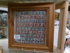 A pine 19th century framed sampler, Lizzie Saywell Carlton, aged 9.