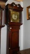 A 30 hour inlaid oak Grandfather clock with brass face and painted centre.