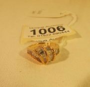 An unusual design 18ct gold ring set with baguette diamonds, size L.