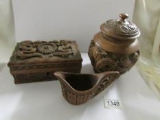 A carved wood oriental lidded pot, a carved oriental box and a carved cup.