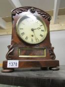 An old mantel clock with key and pendulum.