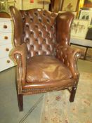A leather wing arm chair.