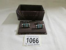 A pair of Ted Baker cuff links.