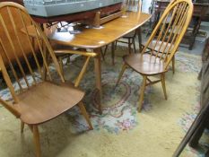An Ercol dining table and a set of 6 Ercol chairs.