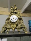 An ornate brass mantel clock surmounted figures, a/f.