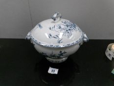 A French blue and white footed tureen with cover.