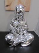 A silver coloured Buddha,