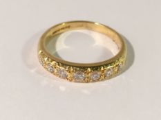 An 18ct gold diamond band ring set 7 diamonds, size L.
