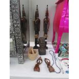 A quantity of carved wood figures, pestle and mortar etc.