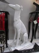 A white painted garden figure of a greyhound.