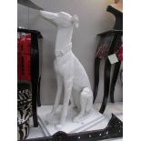 A white painted garden figure of a greyhound.