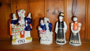 A pair of Hollohaza Hungary porcelain figures and 2 Staffordshire figures.