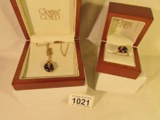 A 9ct Welsh Clogau gold ring and matching pendant on chain set with black stones (probably French