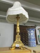 A gilded table lamp with shade.