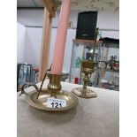 A brass chamber candlestick and a brass candle snuffer in stand.