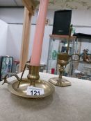 A brass chamber candlestick and a brass candle snuffer in stand.