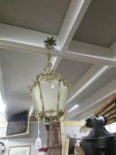 A brass hall lantern with etched panels.