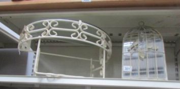 A wrought iron shelf and mirror