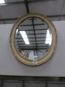 An oval bevel edged mirror.