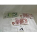 A one pound note and 2 ten shilling notes.