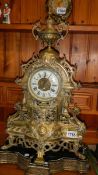 A large ornate brass mantel clock.