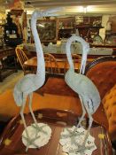A pair of metal storks.
