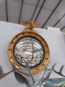 A gilt framed convex mirror.