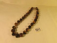 A necklace of natural tiger's eye beads.