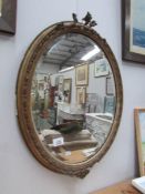 An oval mirror (framed a/f)