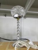 An art deco chrome table lamp with cut glass shade.