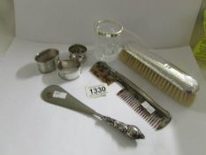 3 silver napkin rings, a hammered silver backed brush Chester 1981/19, a silver backed comb a/f,