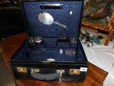 A superb Mappin & Webb travel case with silver topped jars, silver backed mirror and comb head.