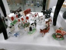 A large collection of Victorian and later cow creamers, some a/f.