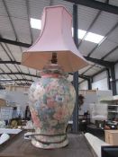 A pottery table lamp with shade.