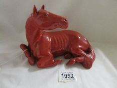 A sculptured/carved oriental figure of a horse.