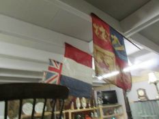 A collection of old flags on sticks.