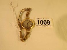 An 18ct gold ladies wrist watch on later rolled gold chain,