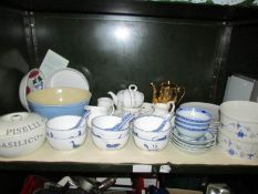 A shelf of miscellaneous including rice bowls and spoons