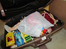 A suitcase of toys including dolls,