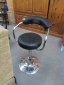 A chrome and black bar stool