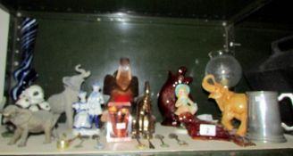 A shelf of miscellaneous figures including elephants etc