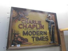 A wooden relief picture of Charlie Chaplin 'Modern Times'