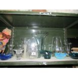 A shelf of assorted glass ware