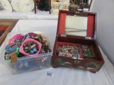 A jewellery box with jewellery and another box of costume jewellery