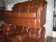 A leather effect three piece suite